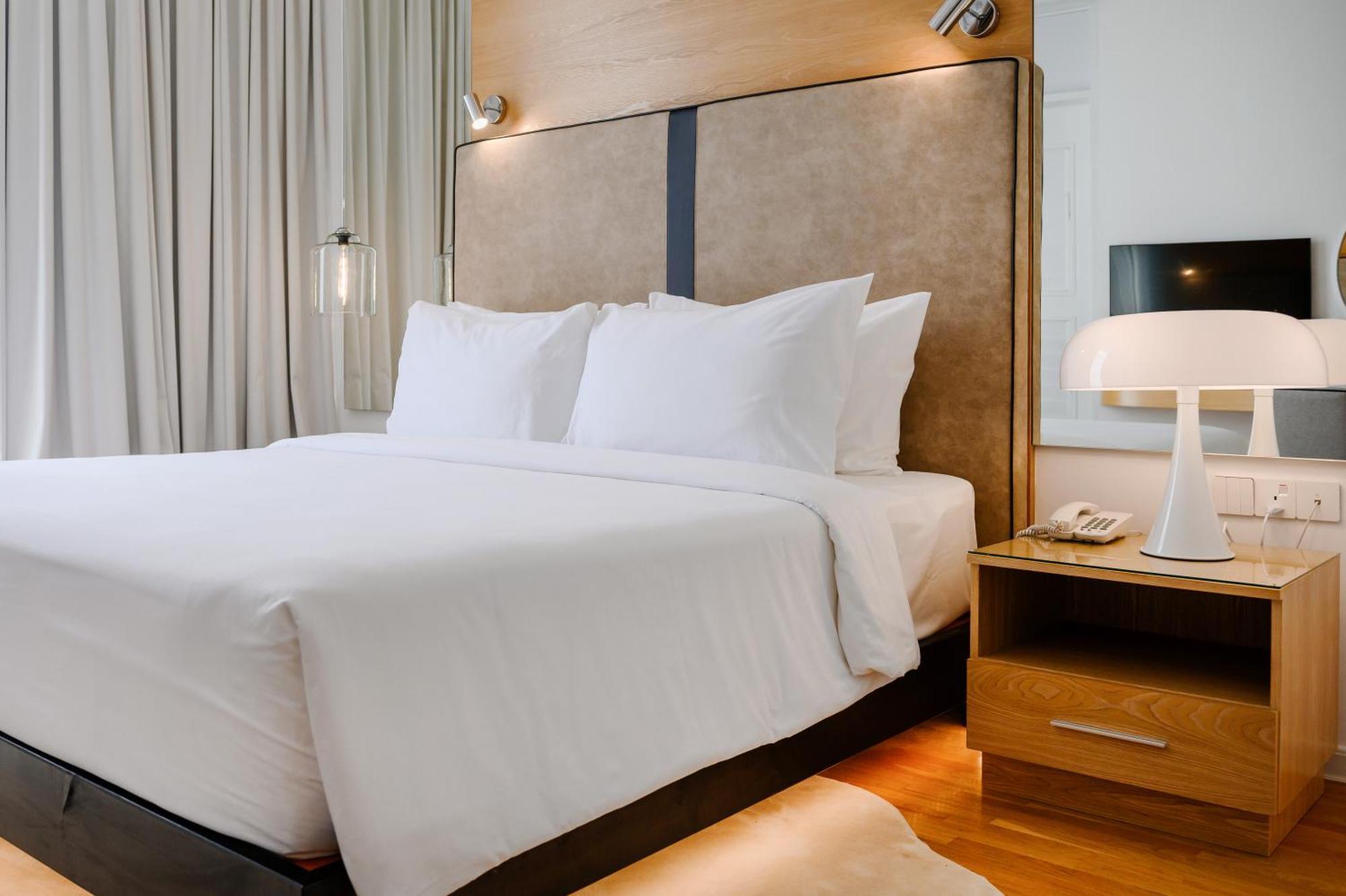 The Riyaz Lavanya Langkawi Pantai Cenang  Exterior foto A bed with a nightstand